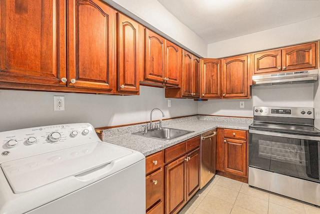 kitchen with sink, appliances with stainless steel finishes, light tile patterned flooring, and washer / dryer