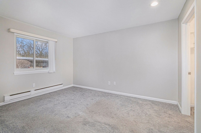 carpeted empty room featuring a baseboard radiator