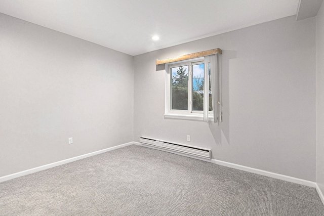 carpeted spare room with baseboard heating