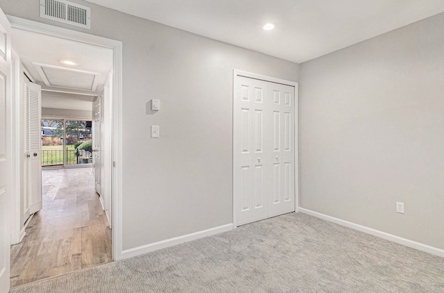 unfurnished bedroom with light hardwood / wood-style floors and a closet