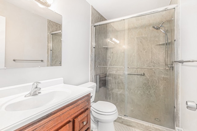 bathroom with tile patterned flooring, vanity, toilet, and walk in shower