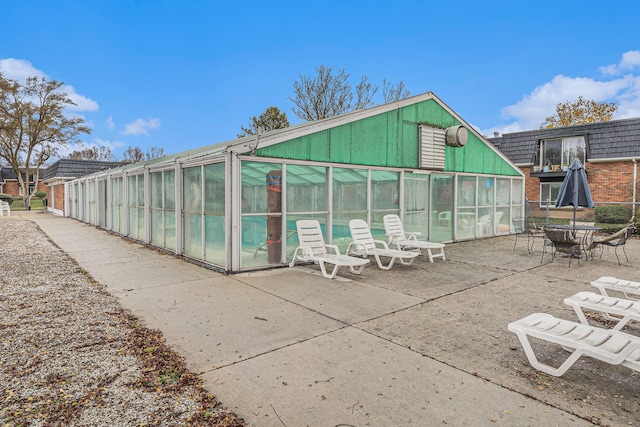 exterior space with a sunroom and a patio area