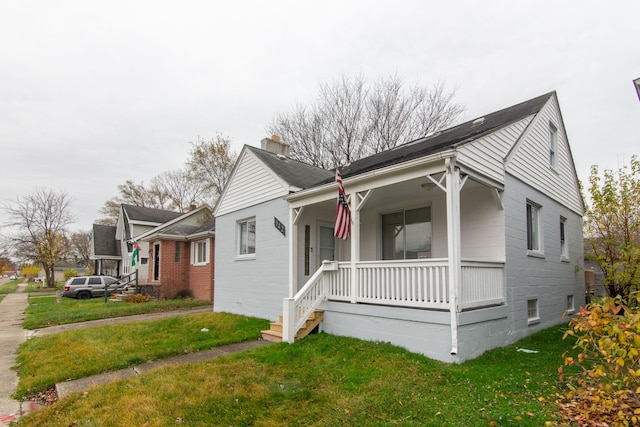 view of front of property with covered porch and a front yard