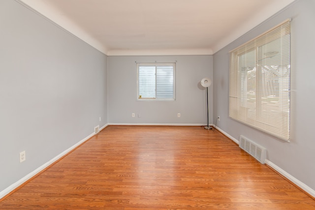 spare room featuring light hardwood / wood-style floors