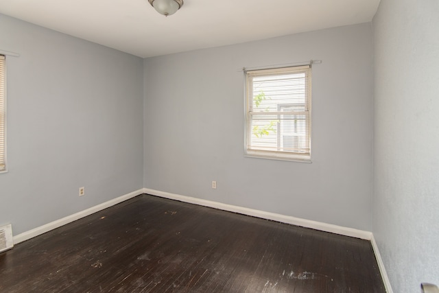 spare room featuring wood-type flooring