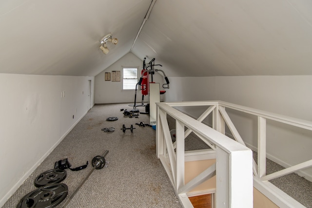 exercise room featuring light colored carpet and lofted ceiling