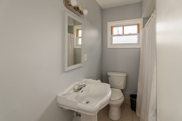 bathroom with tile patterned floors, sink, and toilet