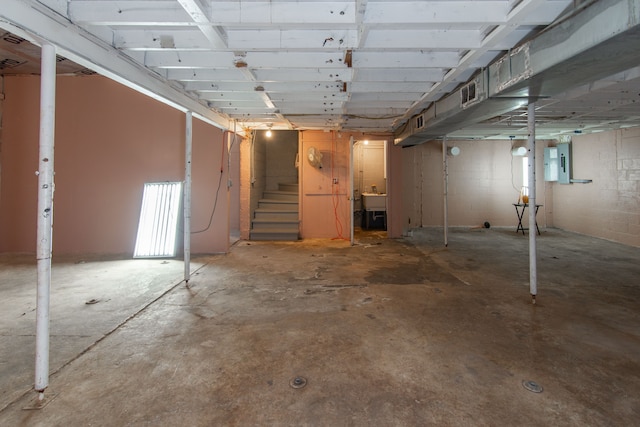 basement with sink and electric panel