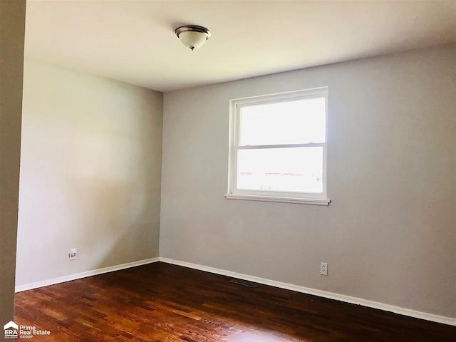 spare room with dark hardwood / wood-style floors