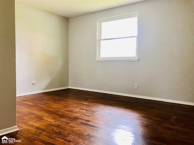 empty room with dark wood-type flooring