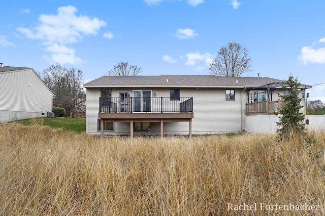 back of property featuring a wooden deck