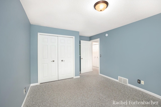 unfurnished bedroom with a closet and carpet floors