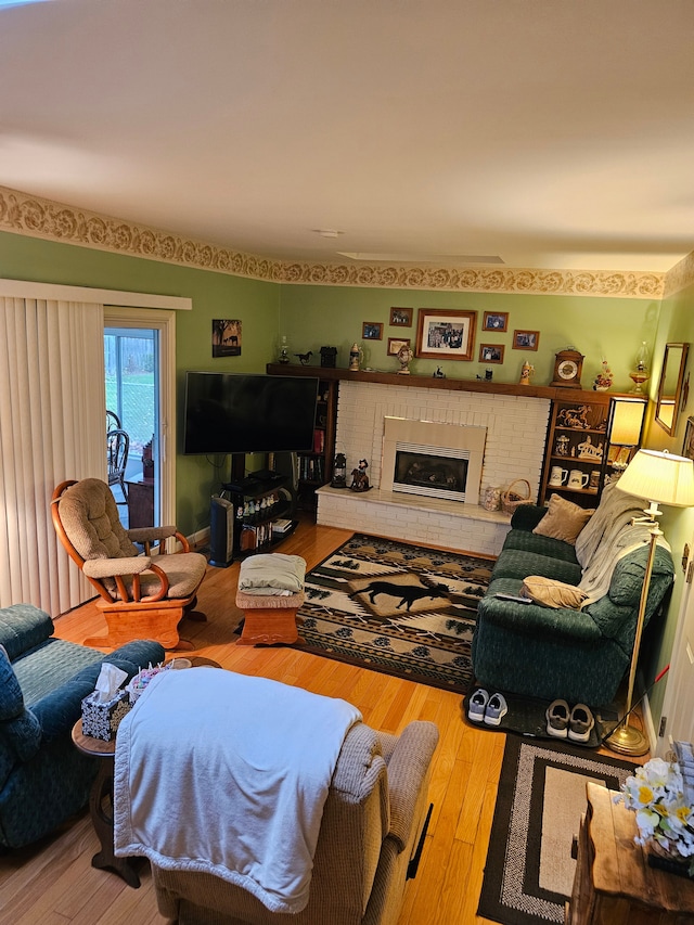 living room with wood-type flooring and a fireplace