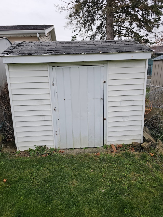 view of outbuilding featuring a lawn