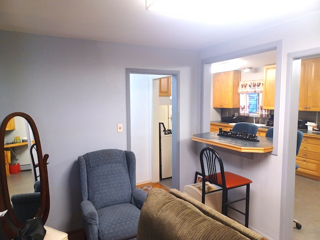 kitchen featuring light brown cabinets and a kitchen bar