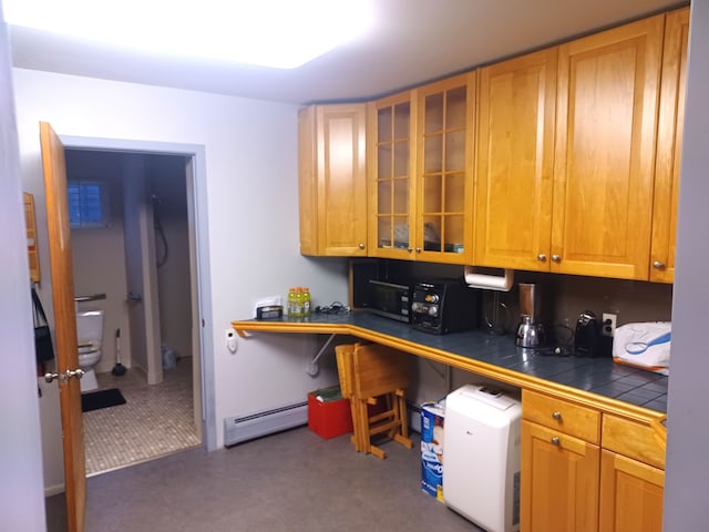 kitchen featuring tile countertops and a baseboard heating unit