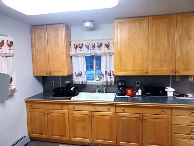 kitchen with tile countertops, sink, and a baseboard heating unit