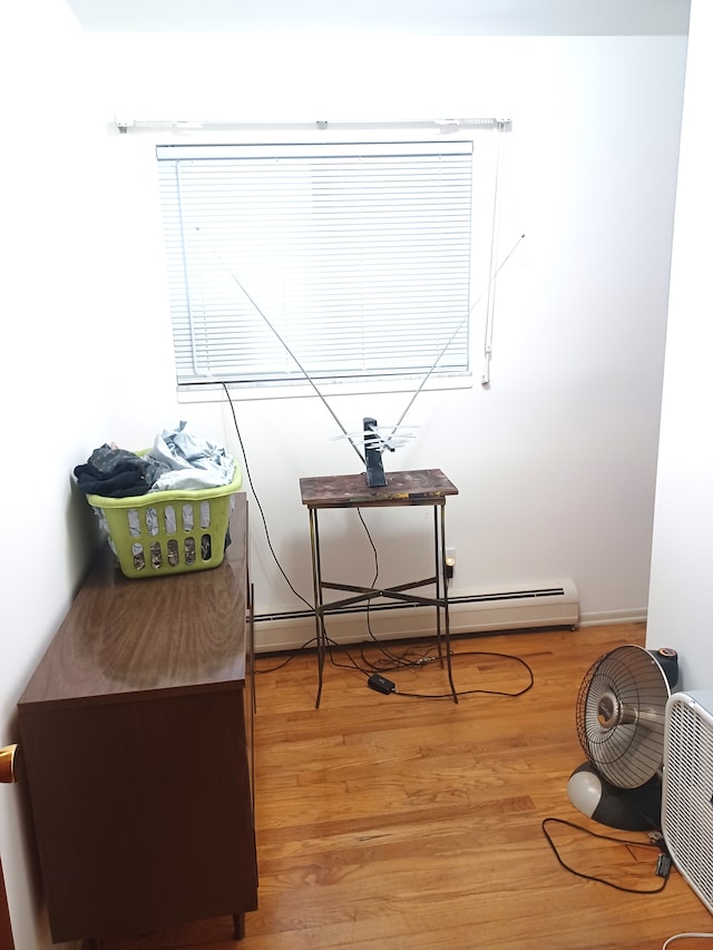 miscellaneous room with hardwood / wood-style floors and a baseboard radiator