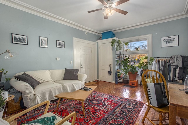 living room featuring crown molding, ceiling fan, and hardwood / wood-style floors