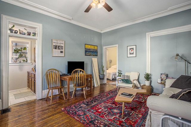 living room featuring dark wood-type flooring, ceiling fan, and ornamental molding