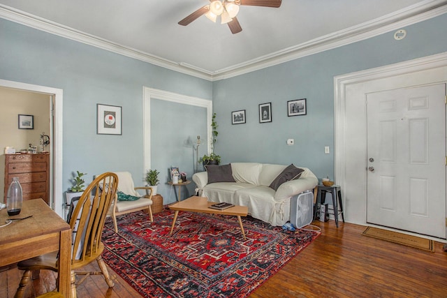 living room featuring crown molding, ceiling fan, and dark hardwood / wood-style flooring