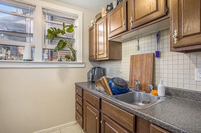 kitchen featuring sink, decorative backsplash, and a wealth of natural light