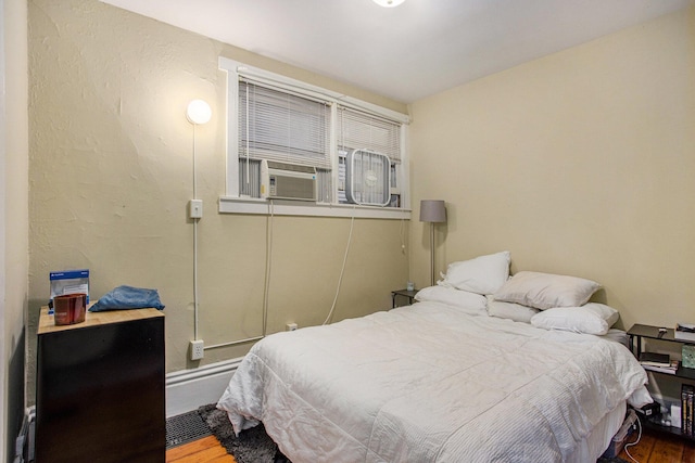 bedroom with hardwood / wood-style flooring and cooling unit