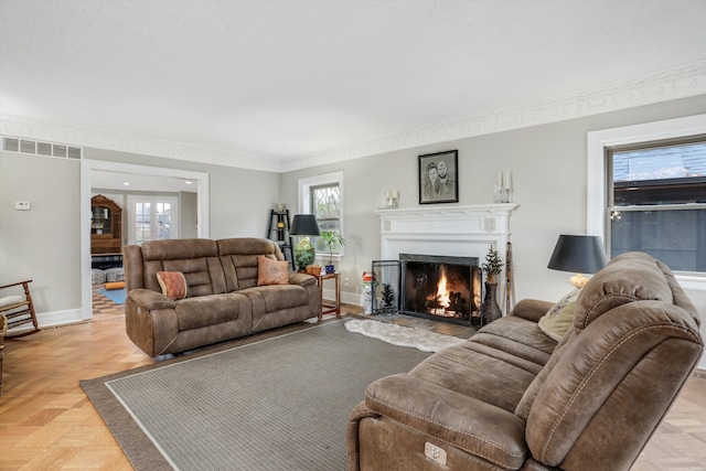 living room with light parquet floors and ornamental molding