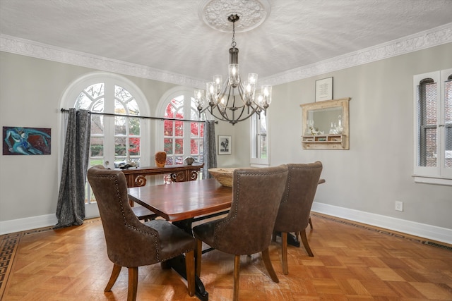 dining space featuring a textured ceiling, a chandelier, crown molding, and light parquet flooring