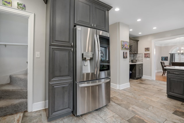 kitchen with a chandelier, stainless steel fridge with ice dispenser, and backsplash