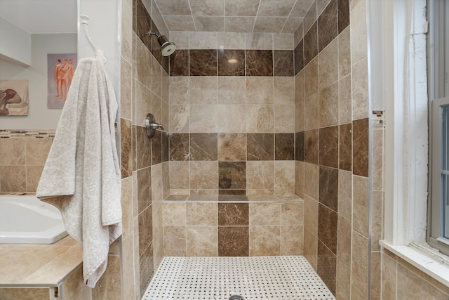 bathroom with tiled shower and tile walls