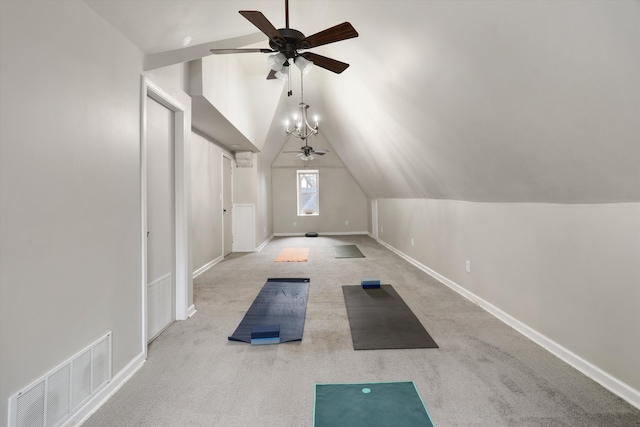 exercise area featuring light carpet, ceiling fan with notable chandelier, and lofted ceiling