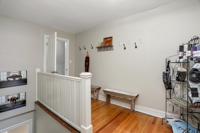 hallway with light hardwood / wood-style floors