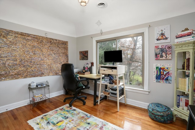 home office with wood-type flooring