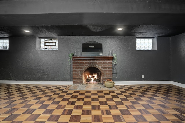 unfurnished living room featuring beam ceiling, a fireplace, and hardwood / wood-style floors