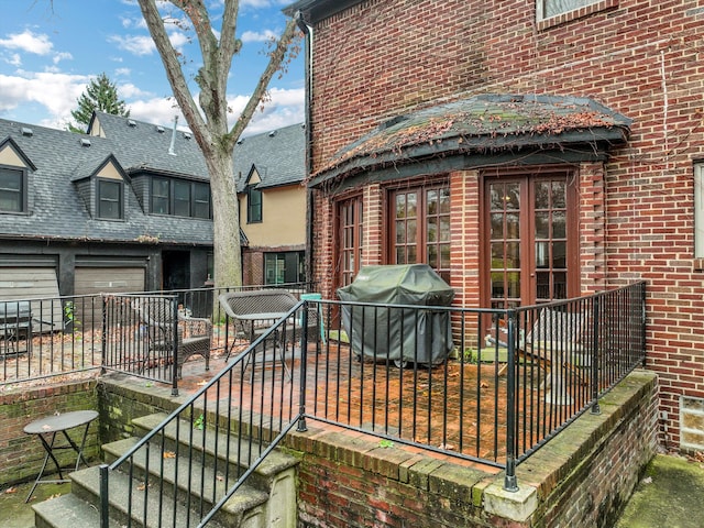 wooden terrace with grilling area and french doors