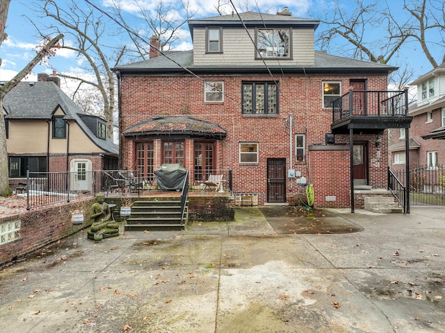 rear view of property with a balcony