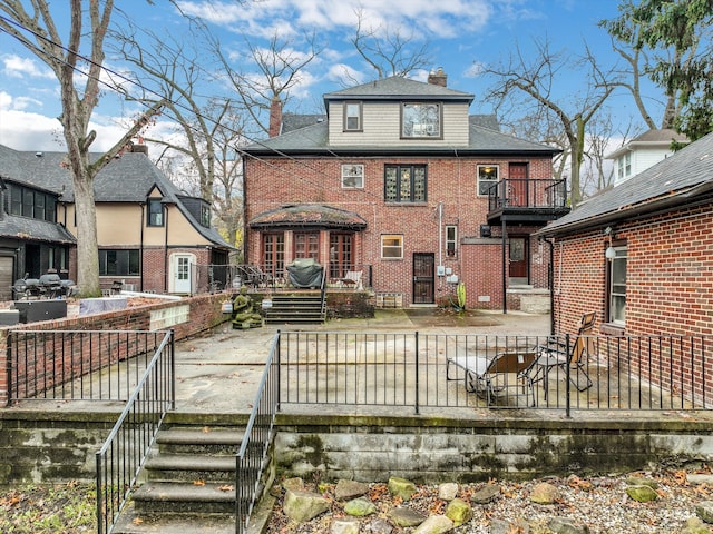 back of property with a balcony