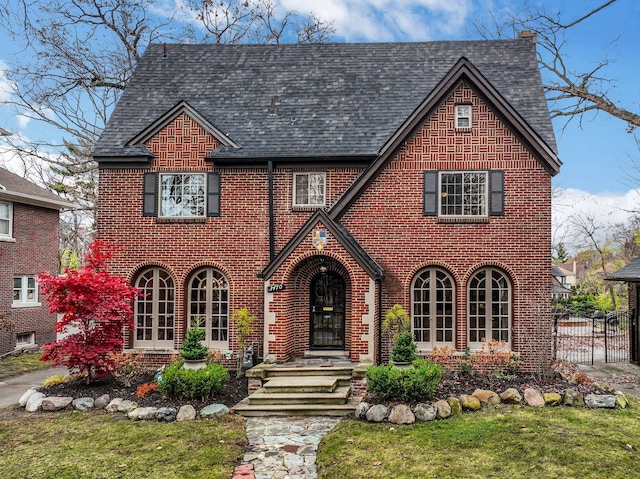 tudor house featuring a front yard