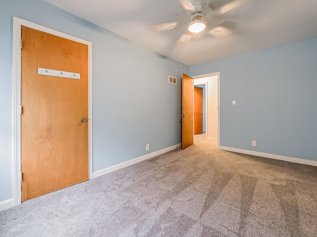 empty room with ceiling fan and carpet floors