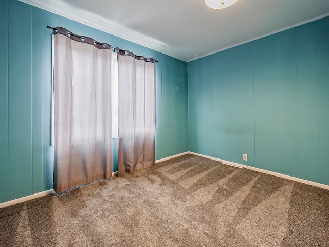 carpeted empty room featuring ornamental molding