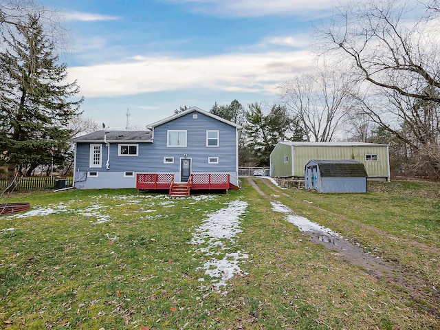 back of property featuring a shed and a yard