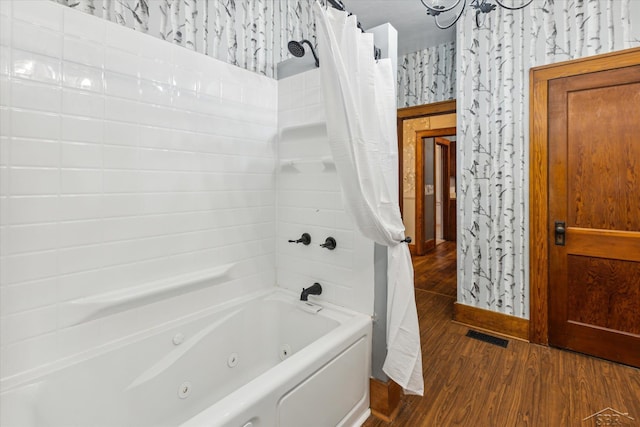 bathroom with hardwood / wood-style flooring and shower / tub combo with curtain