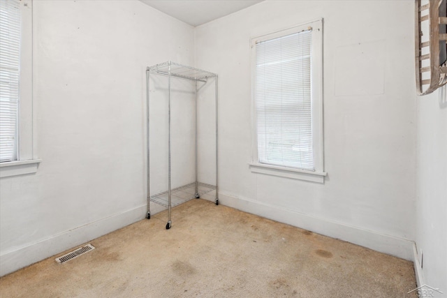 930 E Pine St, Sebewaing, MI 48759 - empty room featuring carpet flooring and healthy amount of natural light