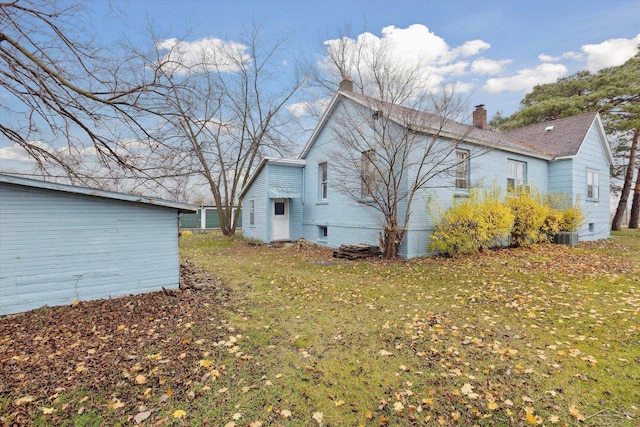 930 E Pine St, Sebewaing, MI 48759 - view of home's exterior with a chimney, central air condition unit, and a lawn
