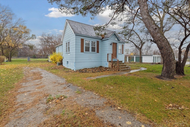 bungalow-style home featuring a front lawn