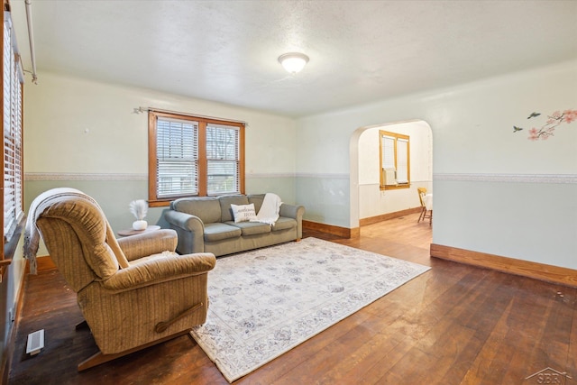 living room featuring hardwood / wood-style flooring and a textured ceiling