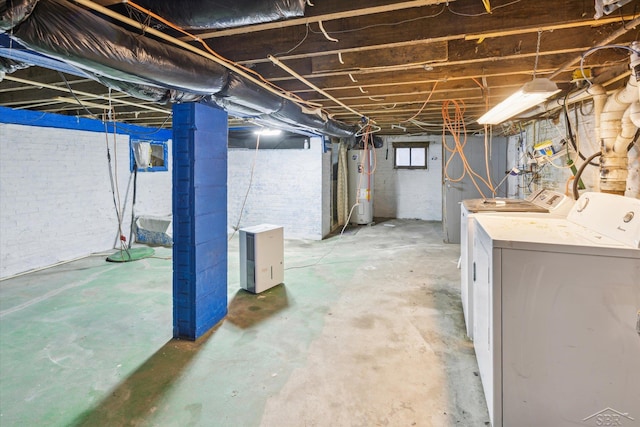 basement with washing machine and dryer and electric water heater