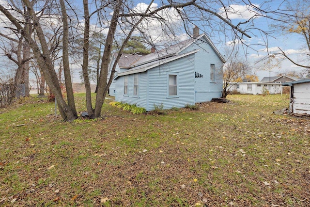 view of property exterior featuring a lawn