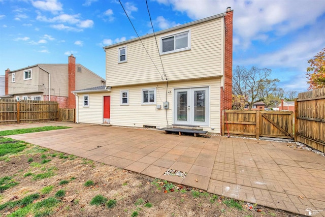 back of property with french doors and a patio area